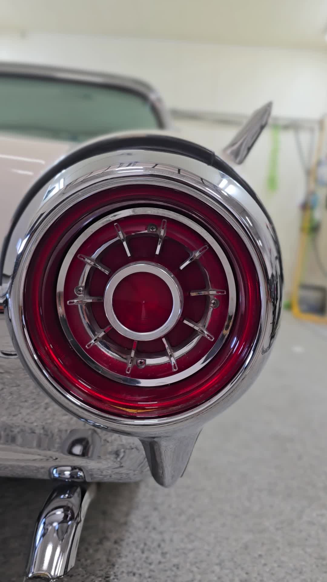 Classic car taillight surrounded by polished chrome