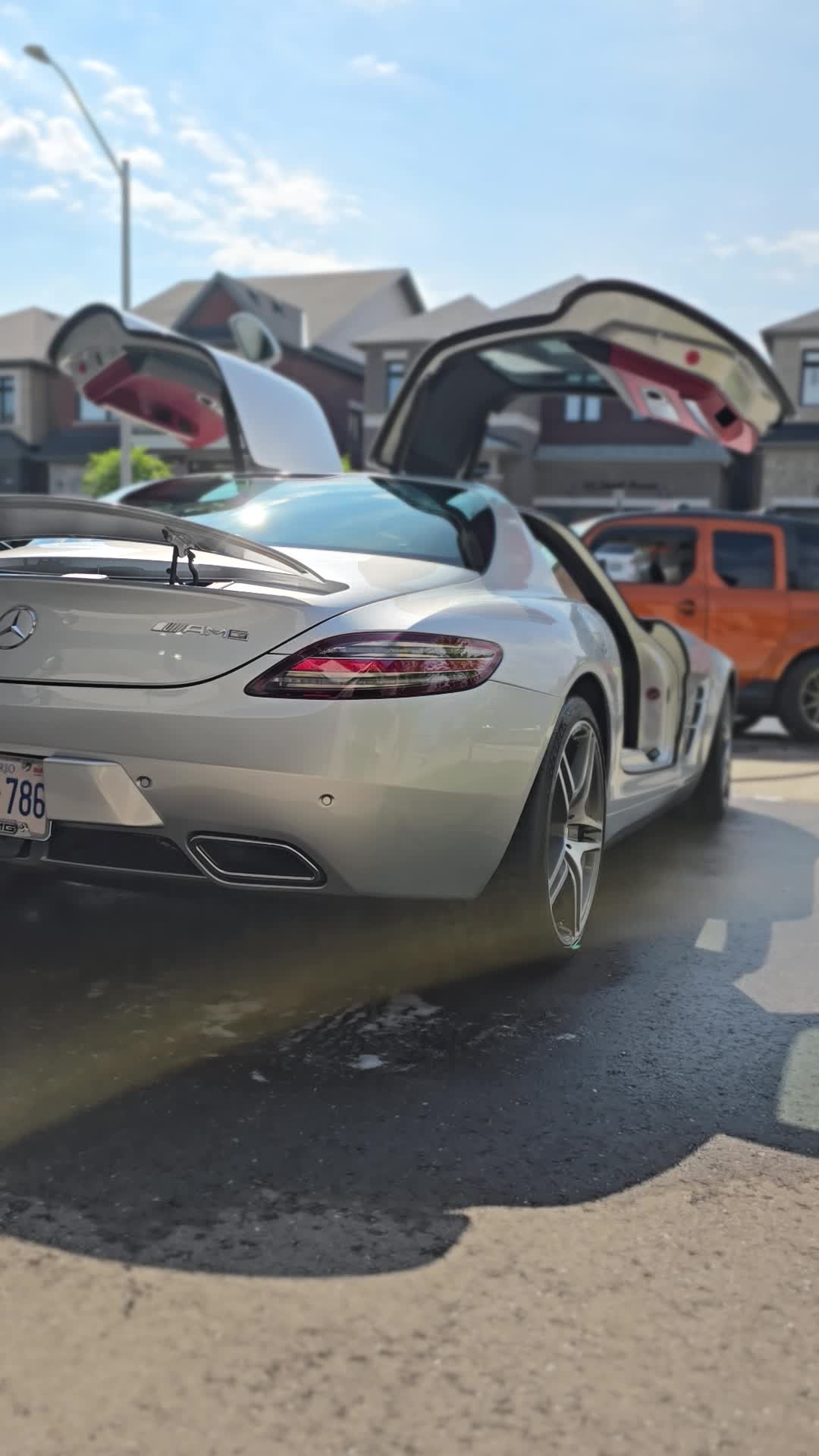 Silver Mercedes-Benz with its gullwing doors open