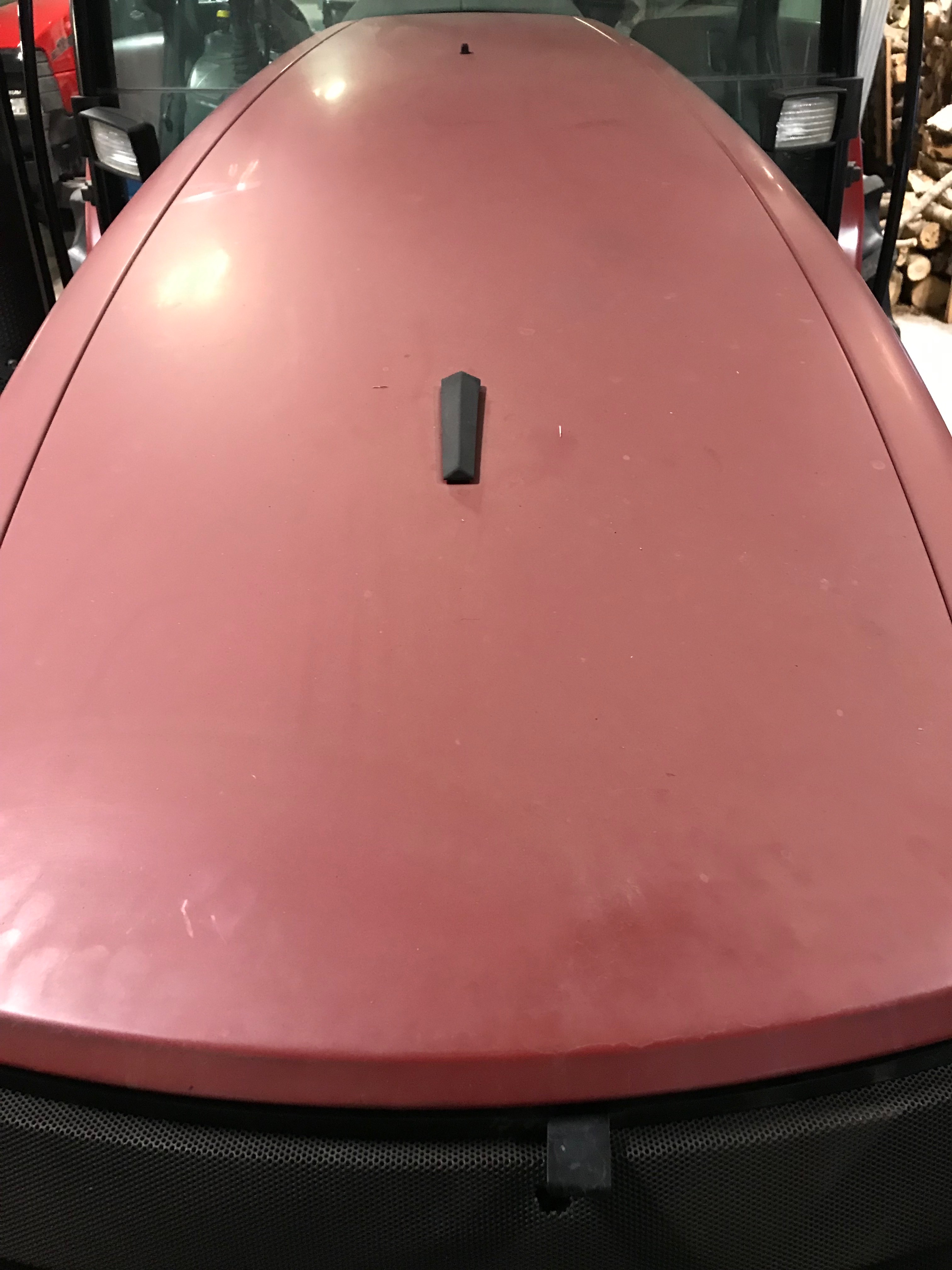 Manufacturer before example: red equipment hood with a dull, faded finish